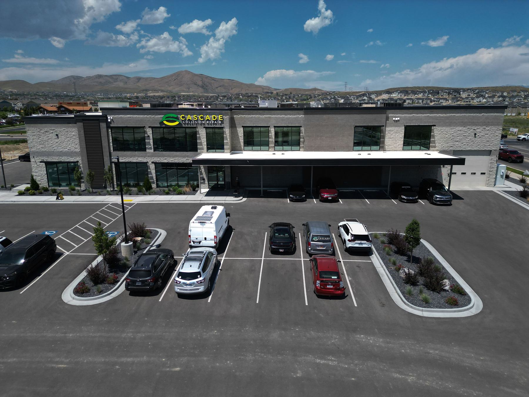 Building and parking with mountains behind