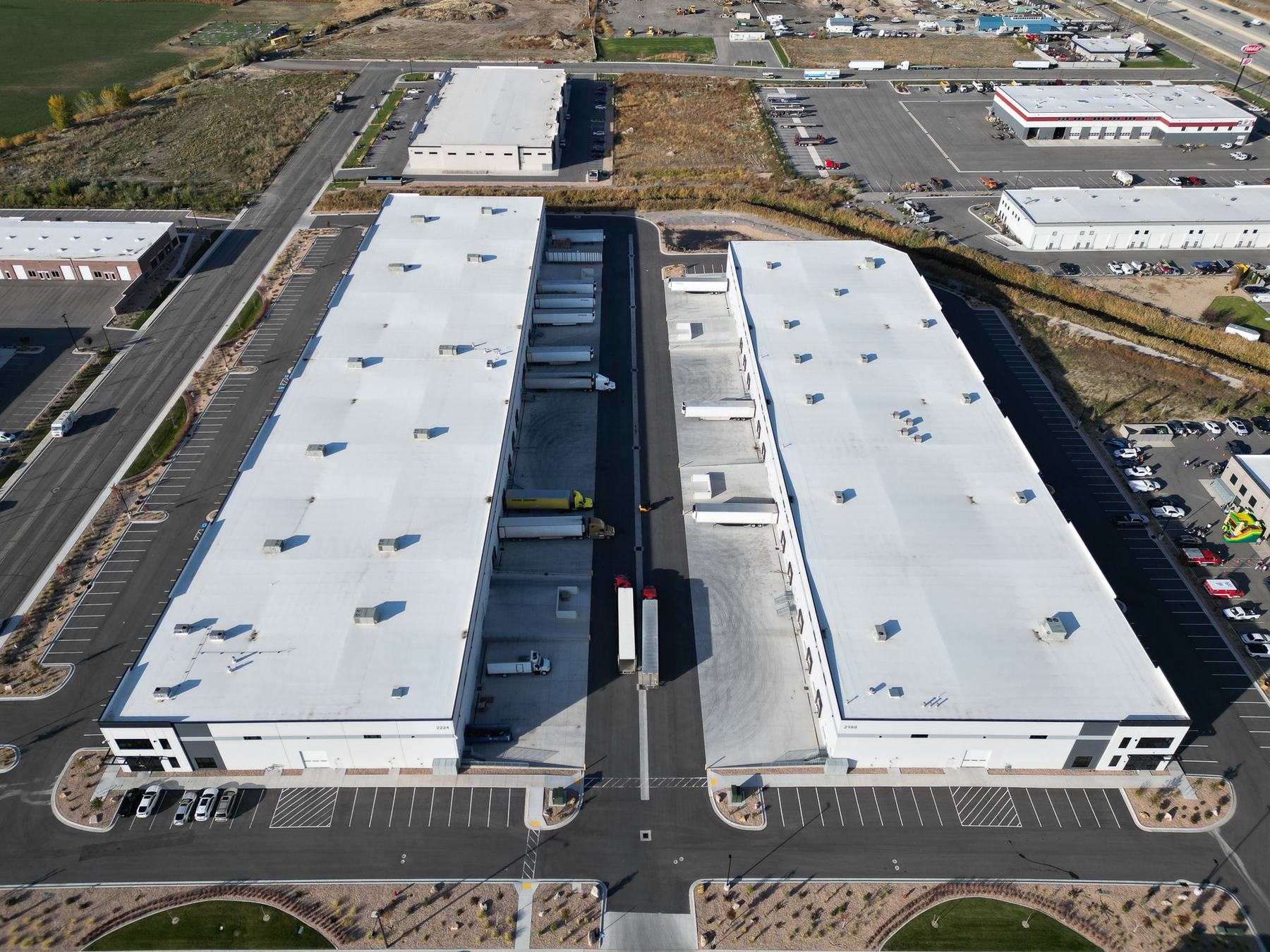 Top-down aerial of two industrial buildings and their truck court
