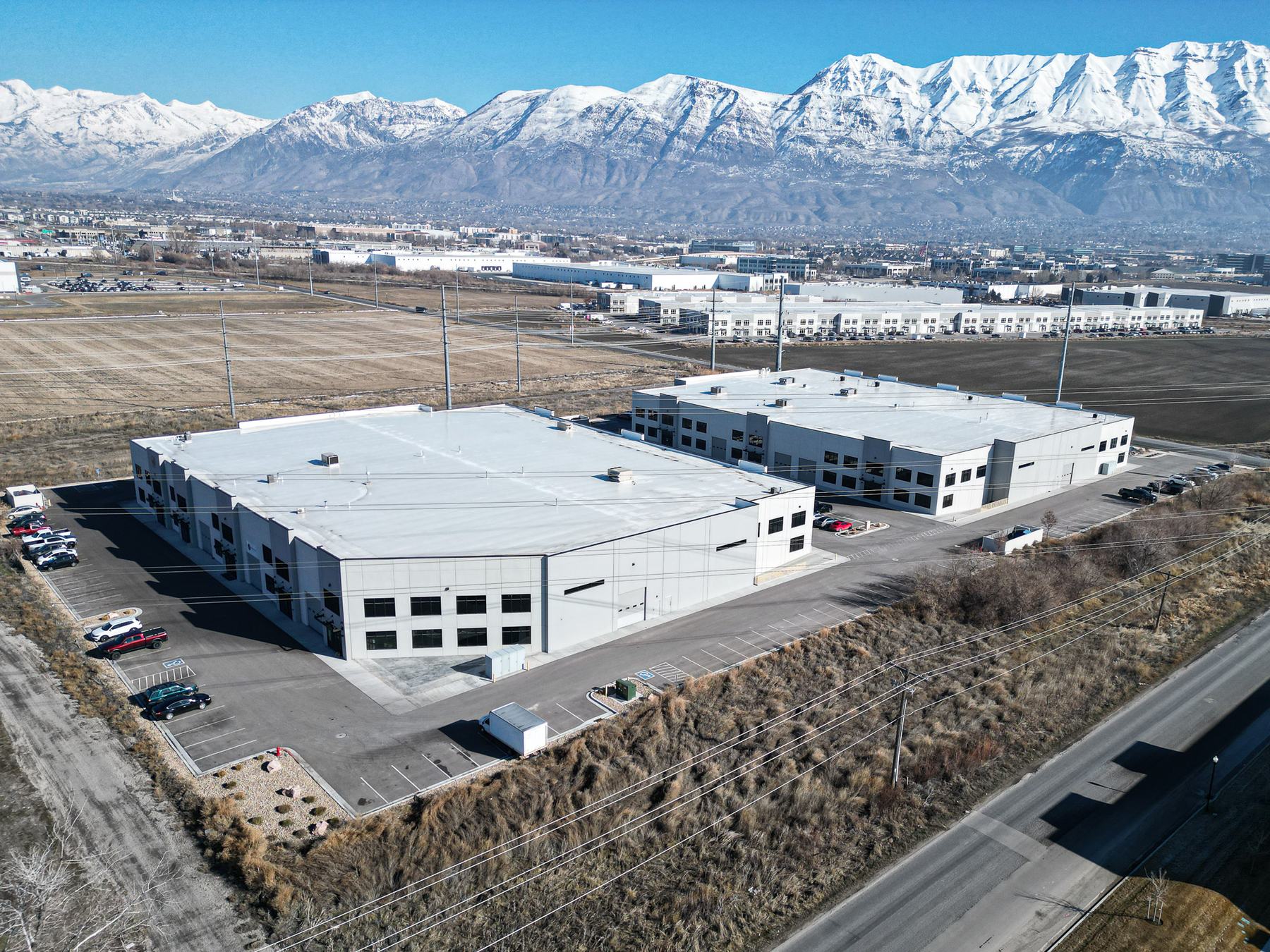 Two flex industrial buildings with snowy mountains behind