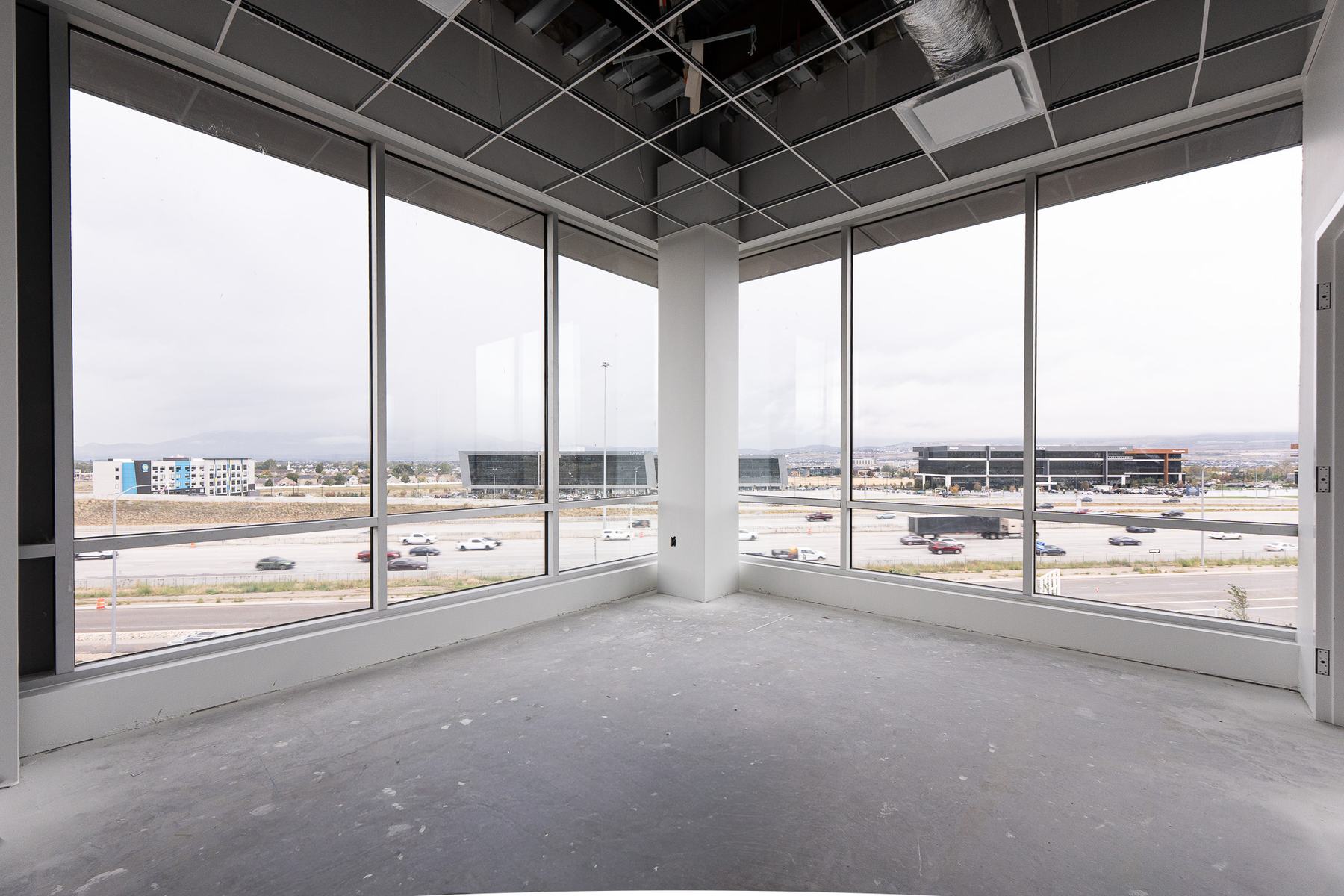 Corner room with wraparound windows and freeway views