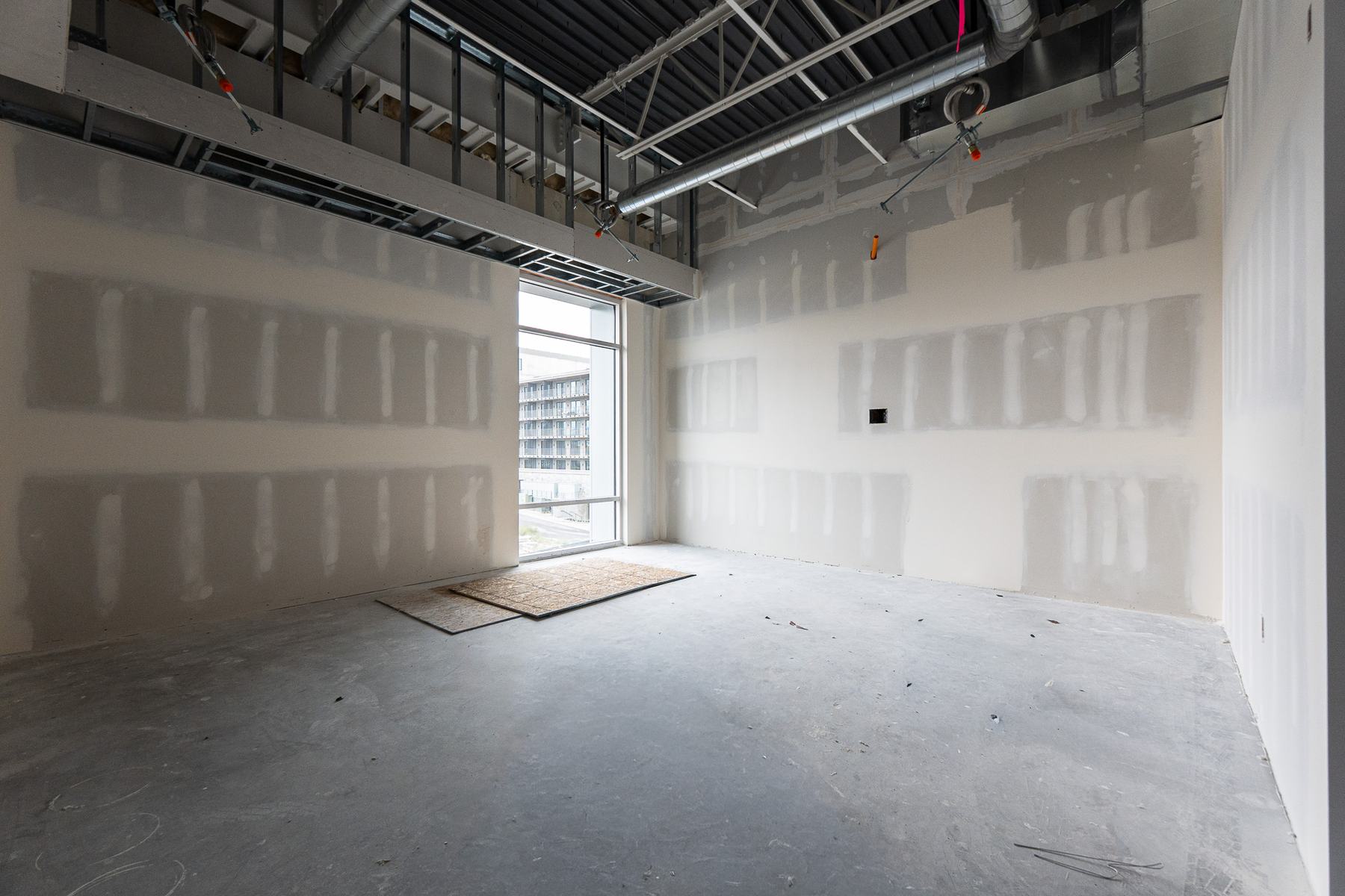 Room with taped and mudded drywall during construction
