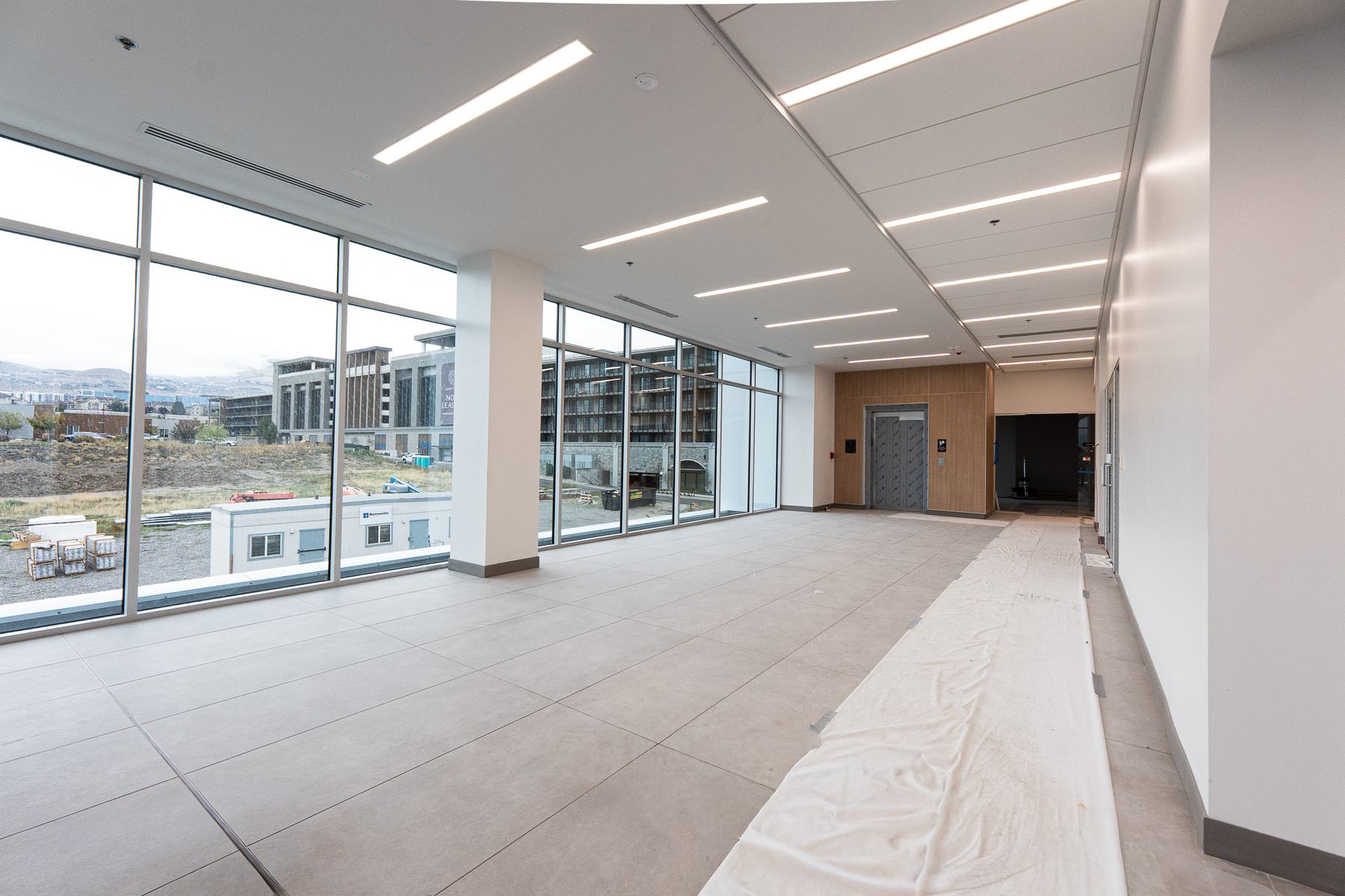 Tiled lobby with a floor-to-ceiling window wall
