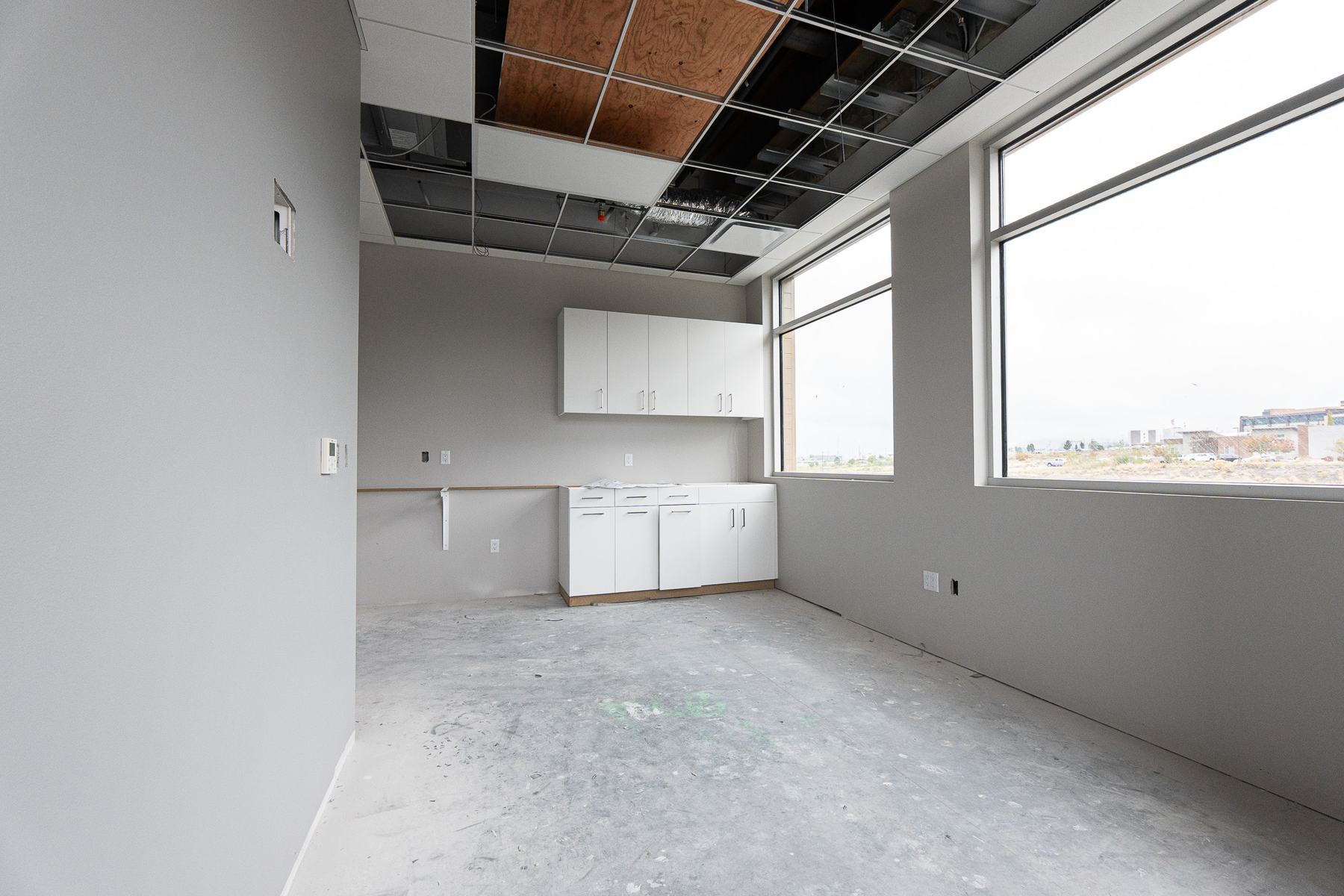 Room with wall cabinets and large windows