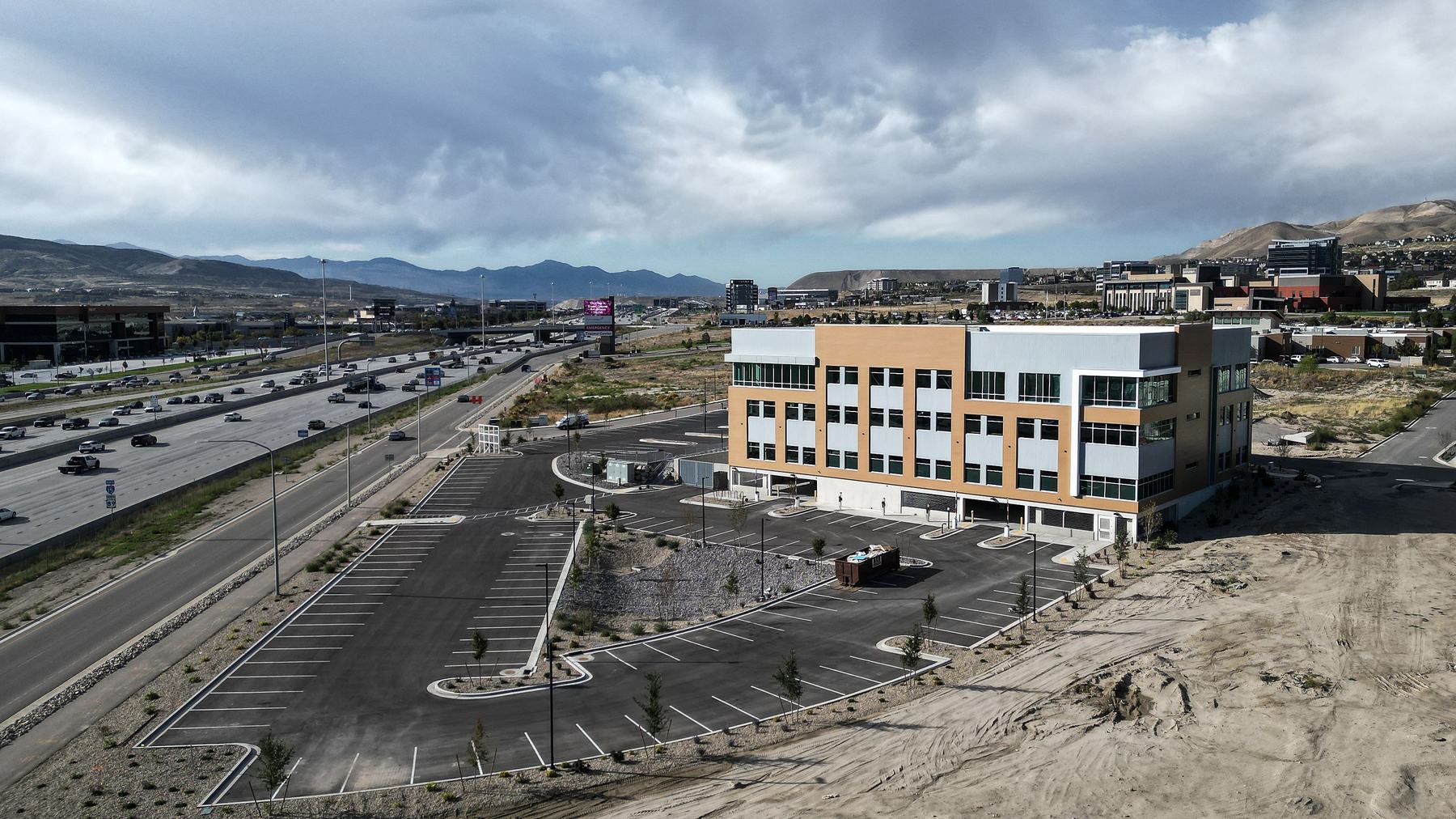 Multi-story office building beside the freeway