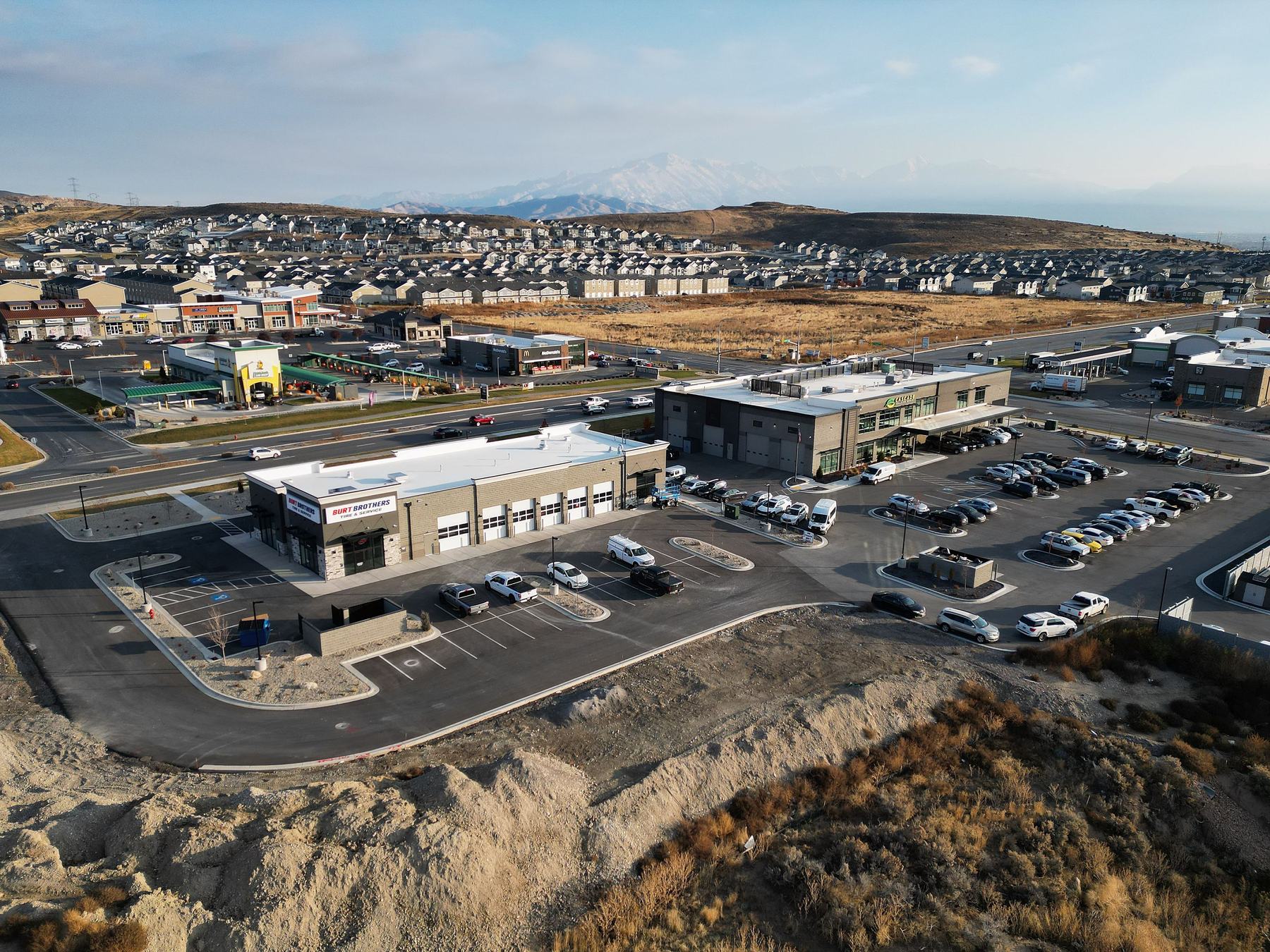 Aerial view of two commercial buildings on developed pad sites