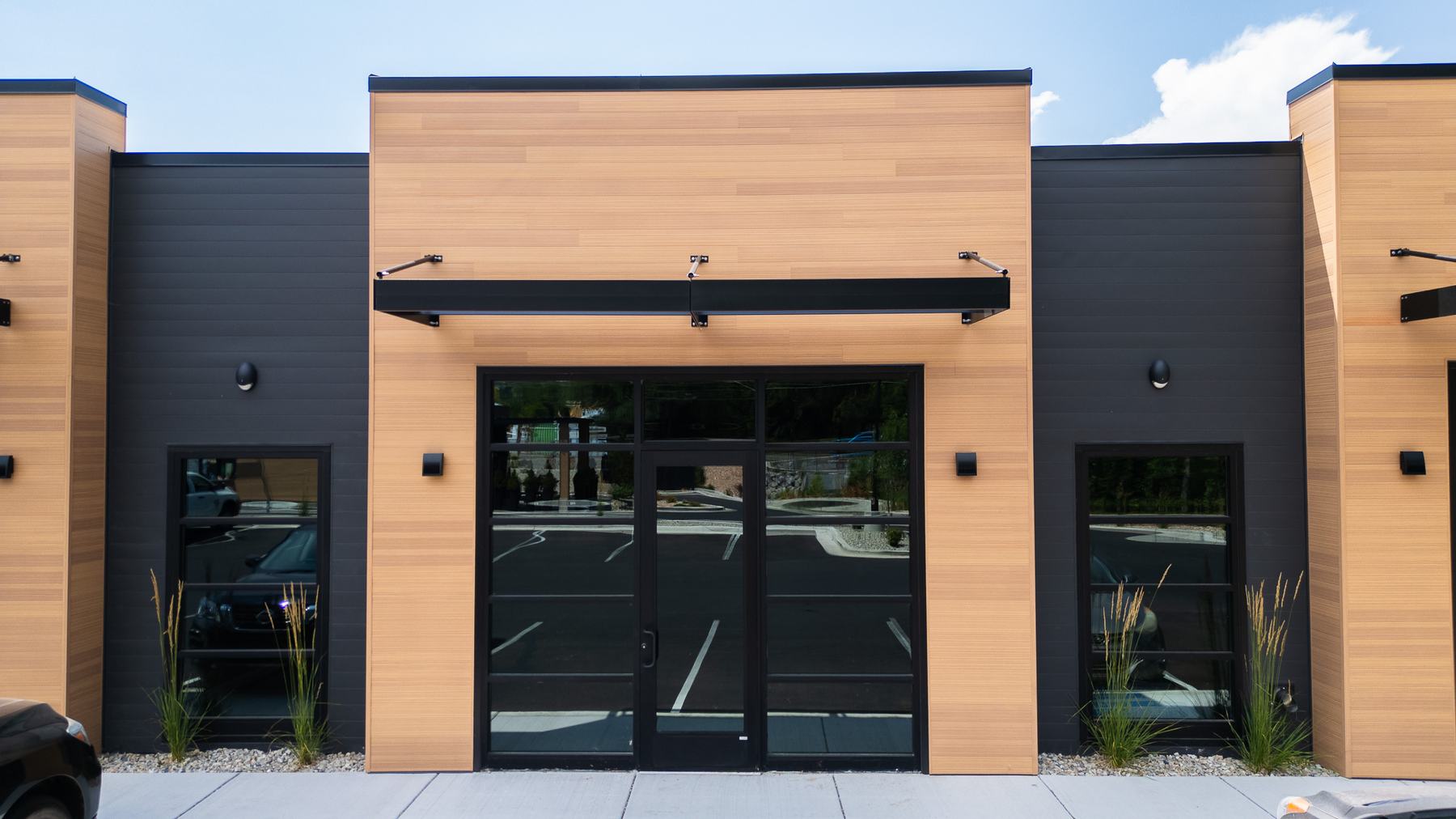 Storefront entry with wood cladding and a steel awning