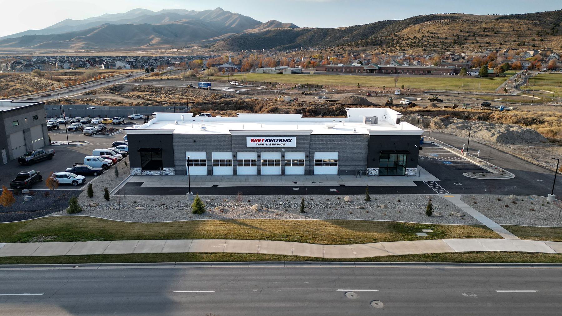 Aerial view of a tire and service center with the mountains behind